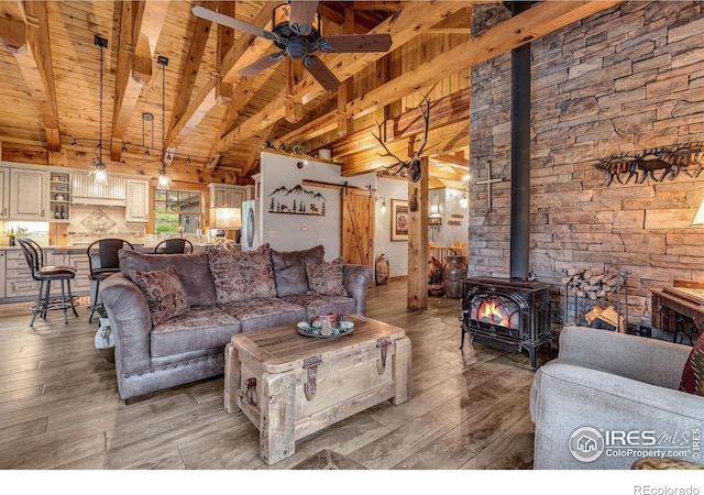 2055 Siskin Dr, Estes Park, CO 80517 - living room featuring wood ceiling, a wood stove, light wood-style flooring, and ceiling fan
