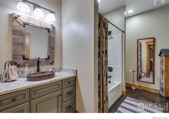 2055 Siskin Dr, Estes Park, CO 80517 - full bathroom featuring vanity, shower / tub combo, a textured wall, and concrete flooring