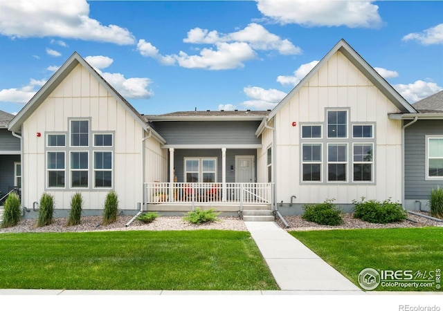 1911 Morningstar Way Unit 2, Fort Collins, CO 80524 - view of front of home featuring board and batten siding, covered porch, and a front lawn