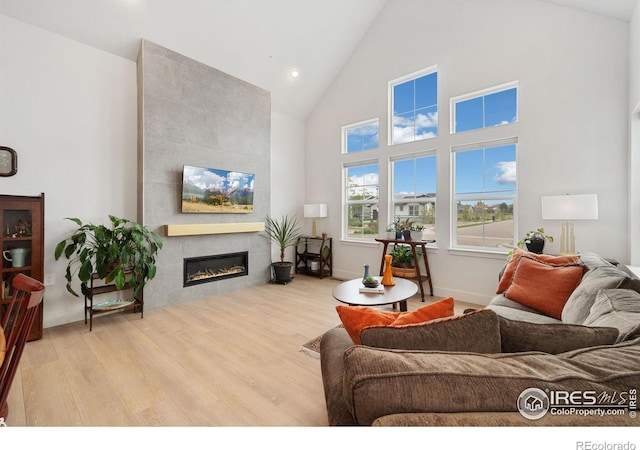 1911 Morningstar Way Unit 2, Fort Collins, CO 80524 - living room with wood finished floors, high vaulted ceiling, a tile fireplace, and recessed lighting