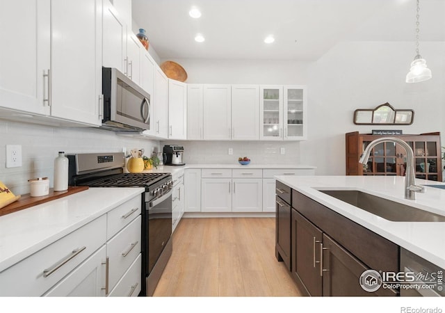 1911 Morningstar Way Unit 2, Fort Collins, CO 80524 - kitchen featuring stainless steel appliances, white cabinetry, backsplash, light wood finished floors, and recessed lighting