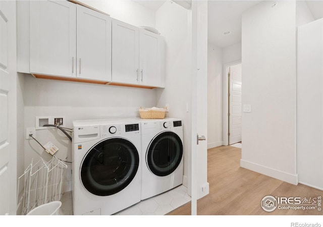1911 Morningstar Way Unit 2, Fort Collins, CO 80524 - laundry area featuring separate washer and dryer, cabinet space, and light wood-style flooring