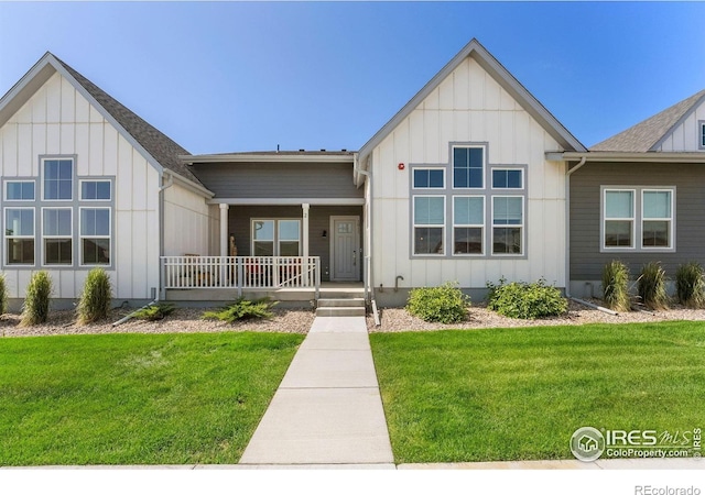 1911 Morningstar Way Unit 2, Fort Collins, CO 80524 - view of front of house with board and batten siding, covered porch, and a front lawn