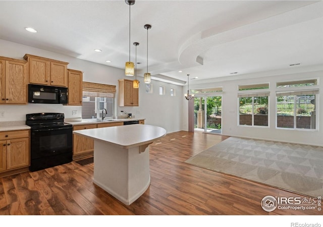 5104 Silverwood Dr, Johnstown, CO 80534 - kitchen with black appliances, light countertops, open floor plan, dark wood-style flooring, and recessed lighting