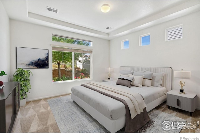 5104 Silverwood Dr, Johnstown, CO 80534 - bedroom featuring a tray ceiling and light colored carpet