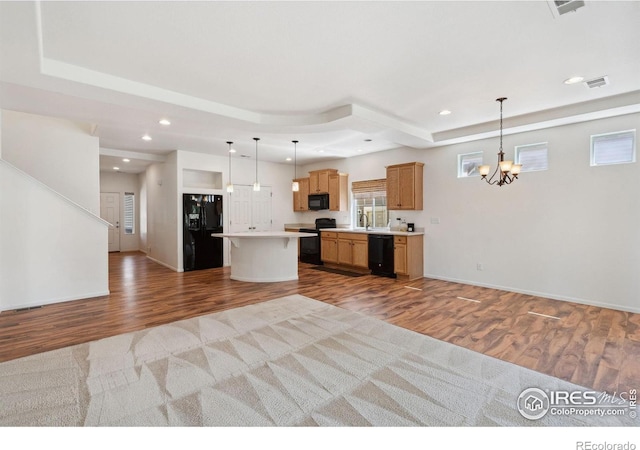 5104 Silverwood Dr, Johnstown, CO 80534 - kitchen with black appliances, open floor plan, wood finished floors, and recessed lighting