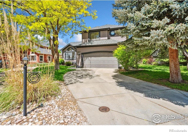 1967 Rangely Ct, Loveland, CO 80538 - view of front of property with driveway, a garage, a front yard, and stucco siding