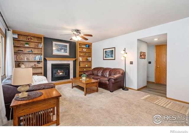 1967 Rangely Ct, Loveland, CO 80538 - carpeted living area featuring a ceiling fan and a glass covered fireplace