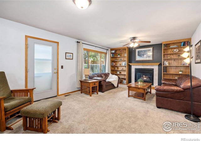 1967 Rangely Ct, Loveland, CO 80538 - carpeted living room with a glass covered fireplace, a ceiling fan, and built in features