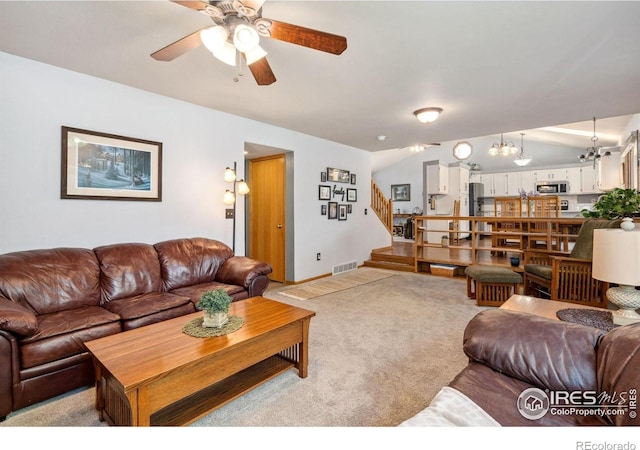 1967 Rangely Ct, Loveland, CO 80538 - carpeted living area featuring ceiling fan, stairs, a chandelier, and lofted ceiling