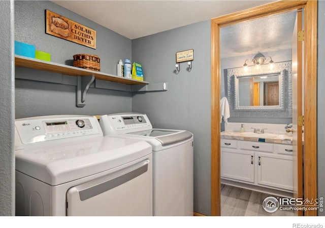 1967 Rangely Ct, Loveland, CO 80538 - laundry room featuring washing machine and dryer and wood finished floors