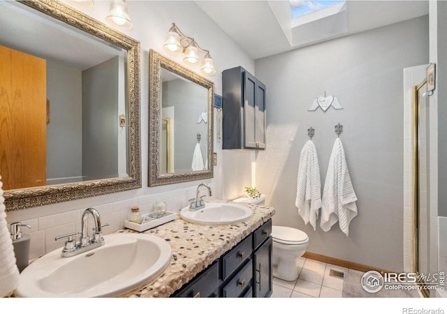 1967 Rangely Ct, Loveland, CO 80538 - full bathroom with a skylight, tile patterned floors, double vanity, and a shower with shower door