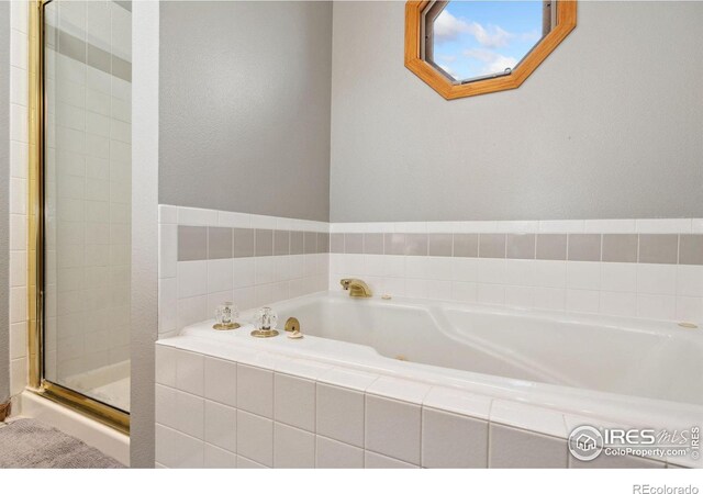 1967 Rangely Ct, Loveland, CO 80538 - bathroom featuring a garden tub and a stall shower