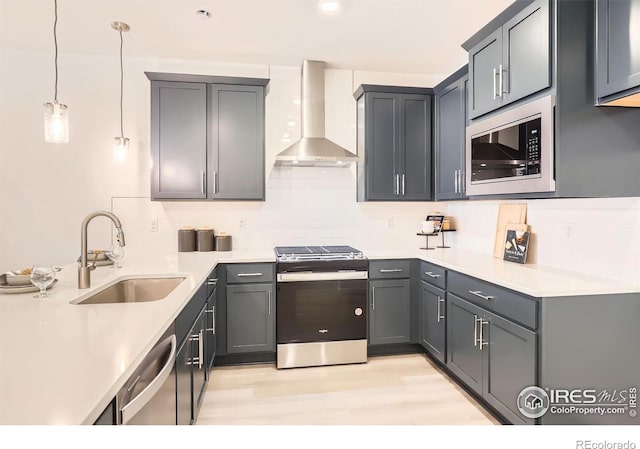 2744 Bear Springs Cir, Longmont, CO 80503 - kitchen with appliances with stainless steel finishes, wall chimney range hood, decorative backsplash, light wood-style flooring, and light countertops
