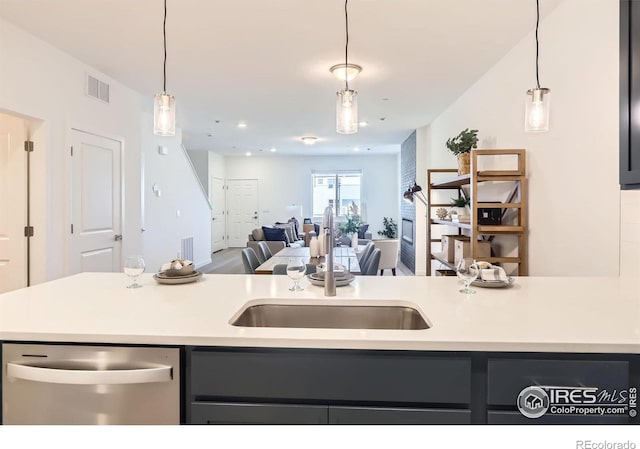 2744 Bear Springs Cir, Longmont, CO 80503 - kitchen featuring stainless steel dishwasher, light countertops, decorative light fixtures, and open floor plan