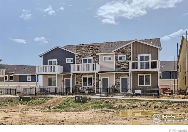 2744 Bear Springs Cir, Longmont, CO 80503 - rear view of property with stone siding and board and batten siding