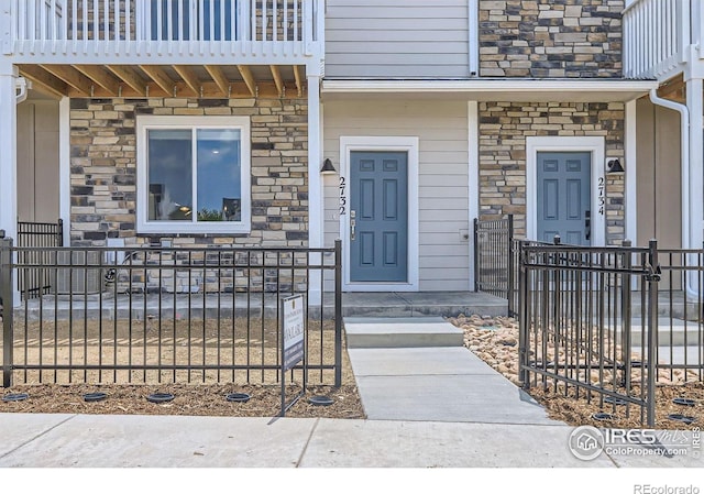 2744 Bear Springs Cir, Longmont, CO 80503 - entrance to property featuring stone siding and covered porch