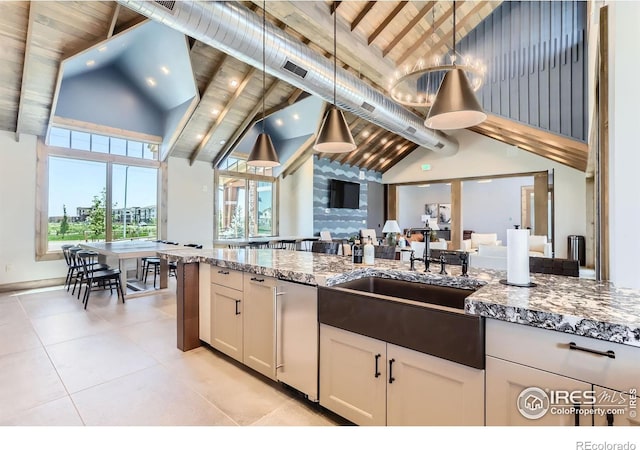 2744 Bear Springs Cir, Longmont, CO 80503 - kitchen featuring high vaulted ceiling, white cabinetry, stone counters, decorative light fixtures, and a wood ceiling with exposed beams