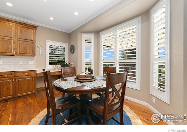6582 Spanish Bay Dr, Windsor, CO 80550 - dining space with healthy amount of natural light, wood finished floors, ornamental molding, and recessed lighting