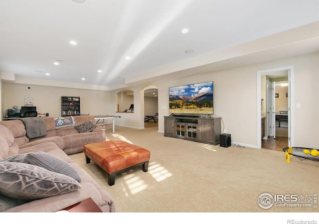 6582 Spanish Bay Dr, Windsor, CO 80550 - living room featuring arched walkways, carpet floors, and recessed lighting