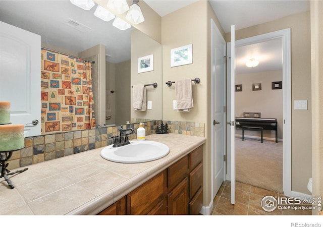 6582 Spanish Bay Dr, Windsor, CO 80550 - bathroom with vanity, tile patterned flooring, and tasteful backsplash
