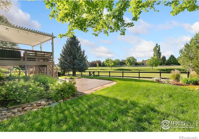 6582 Spanish Bay Dr, Windsor, CO 80550 - view of yard with stairs, a wooden deck, and a patio area