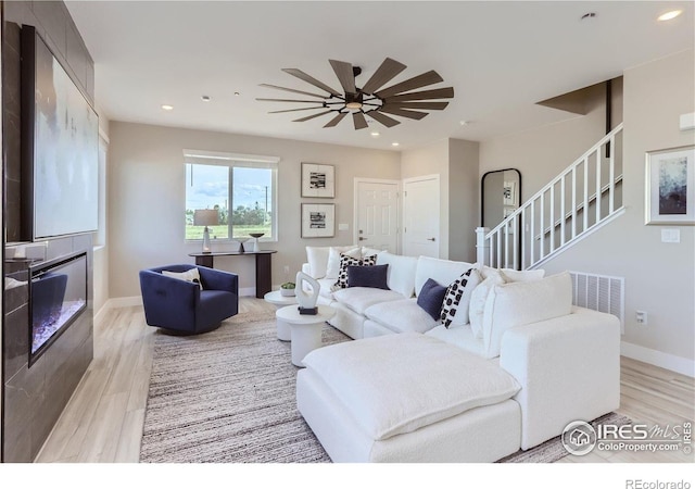 2770 Bear Springs Cir, Longmont, CO 80503 - living area featuring light wood-style flooring, recessed lighting, stairs, and a ceiling fan