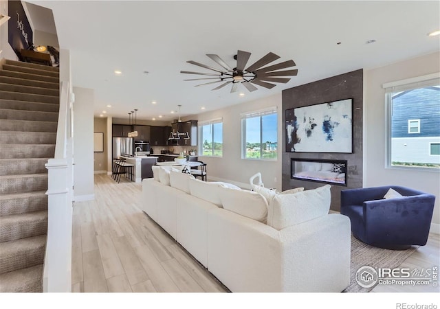 2770 Bear Springs Cir, Longmont, CO 80503 - living room featuring stairway, light wood-style flooring, recessed lighting, and a ceiling fan