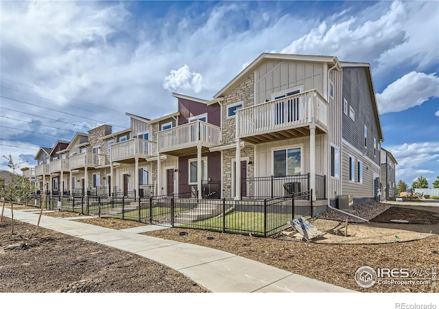 2770 Bear Springs Cir, Longmont, CO 80503 - view of front facade featuring a balcony, board and batten siding, and stone siding