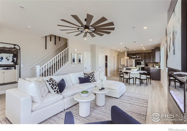 2770 Bear Springs Cir, Longmont, CO 80503 - living room with stairway, light wood-style flooring, recessed lighting, and ceiling fan