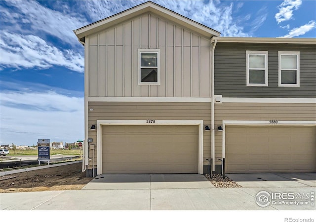 2770 Bear Springs Cir, Longmont, CO 80503 - view of front of property featuring board and batten siding, an attached garage, and driveway