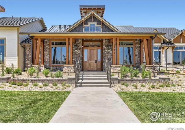2770 Bear Springs Cir, Longmont, CO 80503 - view of front facade with stone siding, a standing seam roof, a front lawn, and a porch