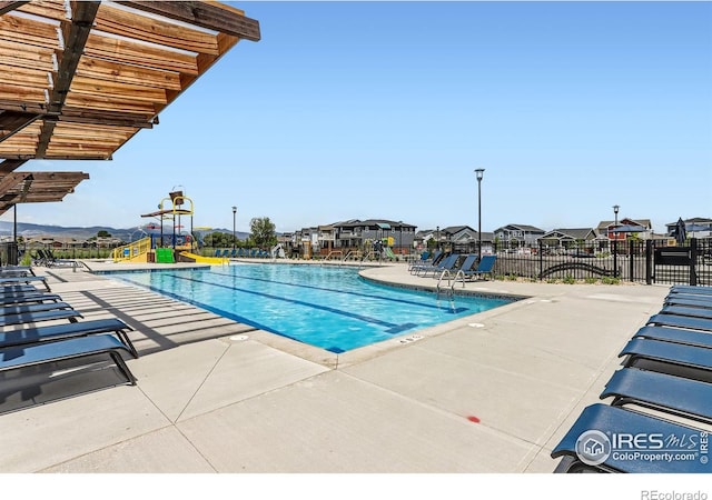 2770 Bear Springs Cir, Longmont, CO 80503 - community pool featuring a patio area and a residential view