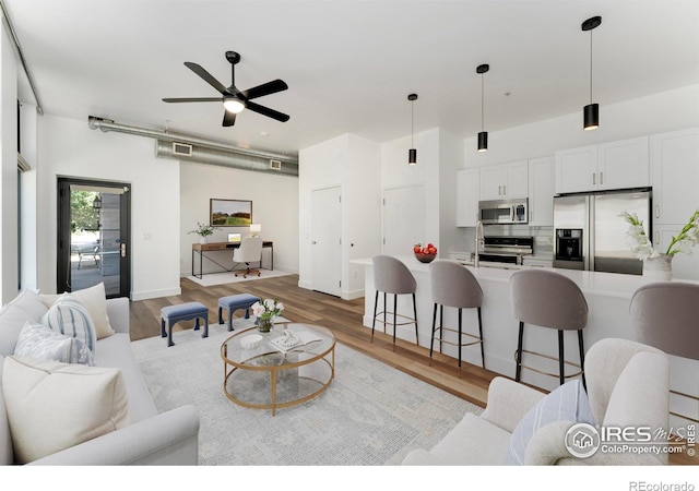 3100 Huron St Unit 1D, Denver, CO 80202 - living room featuring ceiling fan and light wood-type flooring