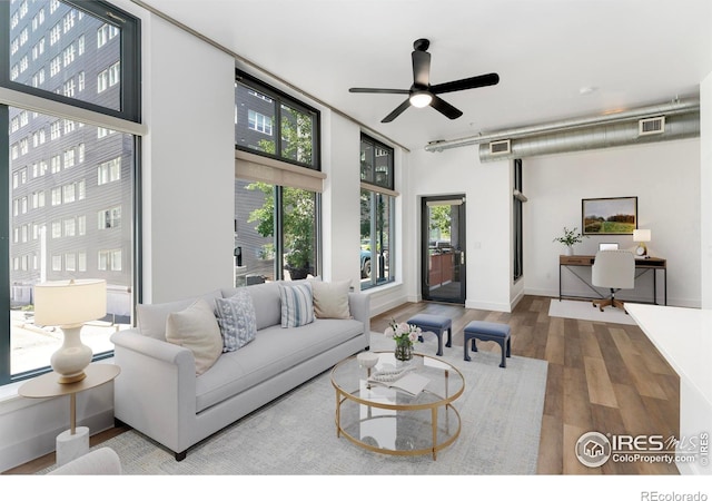 3100 Huron St Unit 1D, Denver, CO 80202 - living area featuring an office area, wood finished floors, and ceiling fan