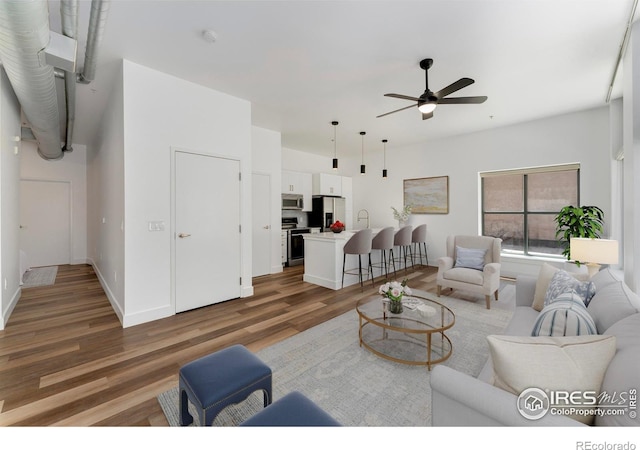 3100 Huron St Unit 1D, Denver, CO 80202 - living area with wood finished floors and a ceiling fan