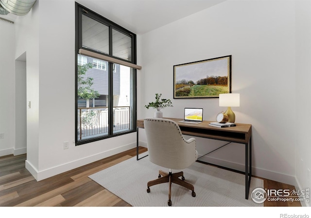 3100 Huron St Unit 1D, Denver, CO 80202 - home office featuring wood finished floors and baseboards