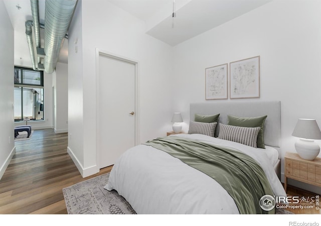 3100 Huron St Unit 1D, Denver, CO 80202 - bedroom featuring wood finished floors and baseboards