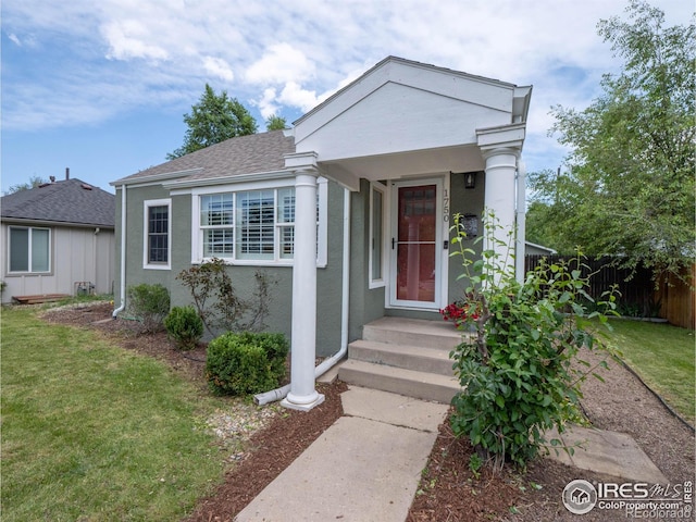 1750 Trenton St, Denver, CO 80220 - view of front of home with stucco siding and a shingled roof
