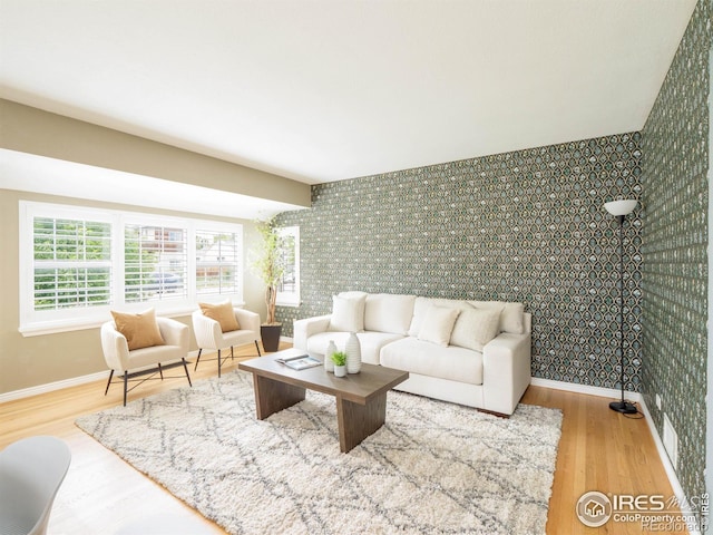 1750 Trenton St, Denver, CO 80220 - living area with wood finished floors, an accent wall, and wallpapered walls