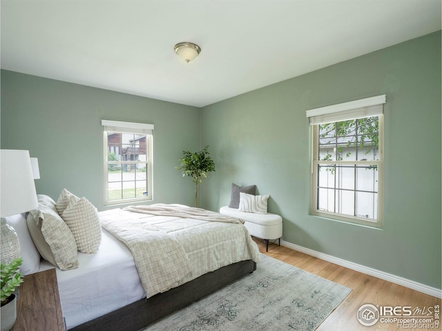 1750 Trenton St, Denver, CO 80220 - bedroom featuring multiple windows and wood finished floors