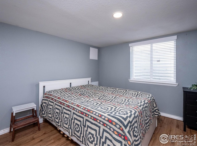 1750 Trenton St, Denver, CO 80220 - bedroom featuring wood finished floors and a textured ceiling