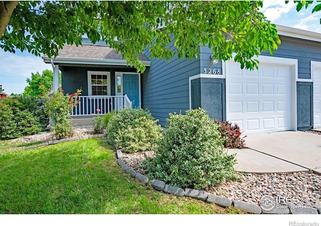 3268 White Buffalo Dr, Wellington, CO 80549 - view of front of home featuring an attached garage, a porch, a front lawn, and driveway