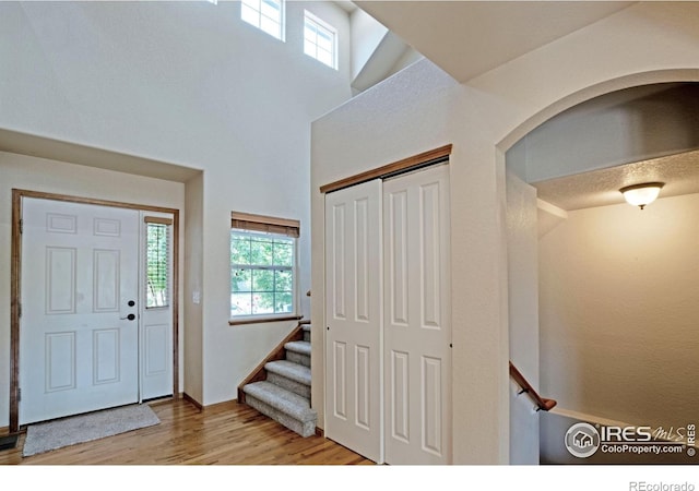 3268 White Buffalo Dr, Wellington, CO 80549 - foyer featuring wood finished floors and stairs