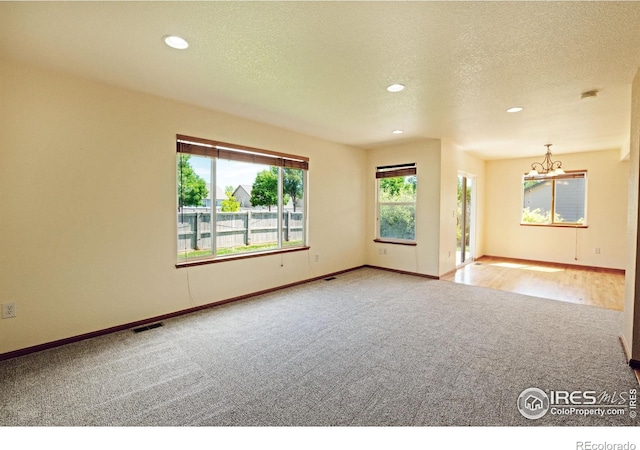3268 White Buffalo Dr, Wellington, CO 80549 - unfurnished room featuring carpet floors, a chandelier, recessed lighting, and a textured ceiling