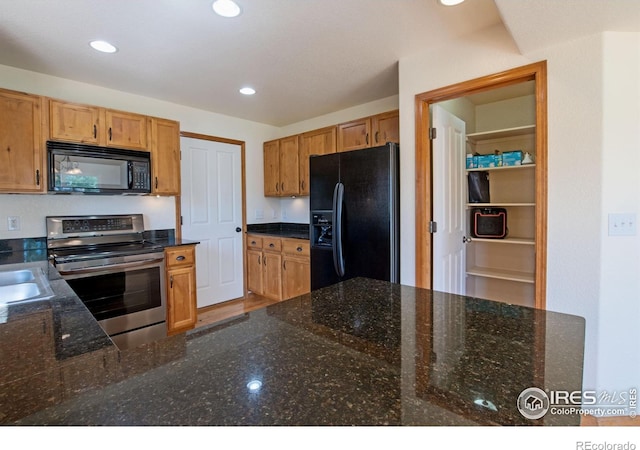 3268 White Buffalo Dr, Wellington, CO 80549 - kitchen featuring black appliances, recessed lighting, and dark stone countertops