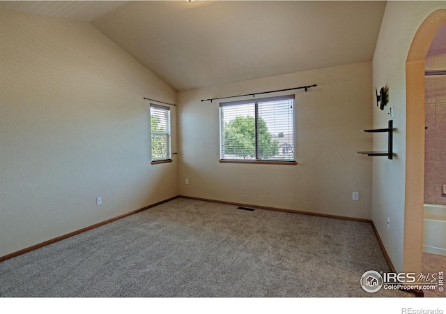 3268 White Buffalo Dr, Wellington, CO 80549 - carpeted spare room featuring lofted ceiling and arched walkways