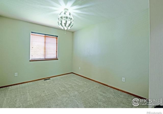 3268 White Buffalo Dr, Wellington, CO 80549 - carpeted empty room with a chandelier and baseboards