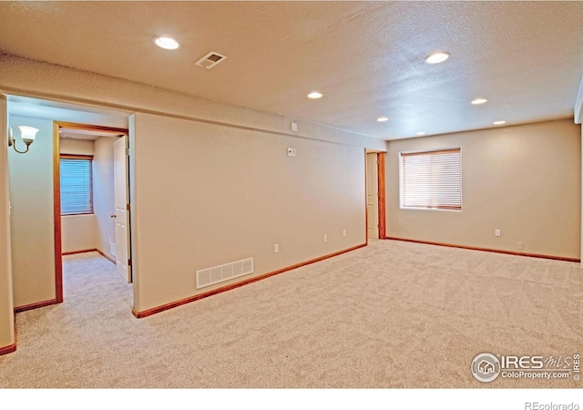 3268 White Buffalo Dr, Wellington, CO 80549 - empty room featuring carpet, recessed lighting, and a textured ceiling