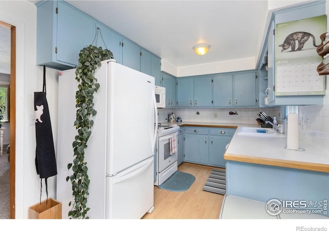 408 Riddle Dr, Fort Collins, CO 80521 - kitchen featuring white appliances, blue cabinets, light wood-style floors, and decorative backsplash